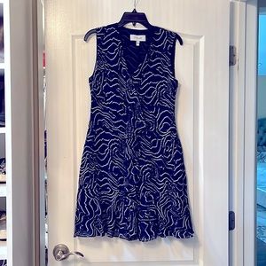 Just below the knee length dress. Dark blue, black and white details.